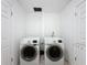 Bright laundry room featuring white washer and dryer, tiled floor and neutral walls at 9201 Tudor Dr # C212, Tampa, FL 33615