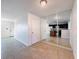 Open concept living room with tile flooring and a mirrored wall reflecting the kitchen and island at 9201 Tudor Dr # C212, Tampa, FL 33615