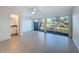 The living room boasts a ceiling fan, and a private balcony overlooking the outdoors at 9201 Tudor Dr # C212, Tampa, FL 33615