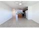 Bright living room area features neutral tiled flooring and a view into the adjacent kitchen at 9201 Tudor Dr # C212, Tampa, FL 33615