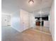 Open concept living room with tile flooring and a mirrored wall reflecting the kitchen and island at 9201 Tudor Dr # C212, Tampa, FL 33615