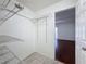 This walk-in closet features wire shelving and tiled floor, with an opening to a bedroom at 9201 Tudor Dr # C212, Tampa, FL 33615
