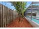 Side view of backyard with privacy fence and screened in pool at 9241 Cochise Ln, Port Richey, FL 34668