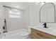 Updated bathroom featuring modern sink, bathtub with shower and natural light at 9241 Cochise Ln, Port Richey, FL 34668