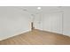 Bedroom with wood floors, closet, and a view to the hallway at 9241 Cochise Ln, Port Richey, FL 34668