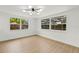 Bedroom with wood floors and dual windows overlooking backyard at 9241 Cochise Ln, Port Richey, FL 34668