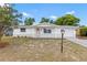 Charming single-story home with a well-maintained lawn and inviting front entrance and covered porch at 9241 Cochise Ln, Port Richey, FL 34668