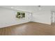 The living space features hardwood flooring, with bright white walls, and a new light-colored entry door at 9241 Cochise Ln, Port Richey, FL 34668