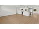 Bright, open-concept living space featuring hardwood floors, a kitchen, stainless appliances, and natural light at 9241 Cochise Ln, Port Richey, FL 34668