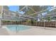 Enclosed backyard pool surrounded by a screened enclosure, offering privacy at 9241 Cochise Ln, Port Richey, FL 34668