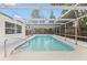 Backyard pool with screened-in enclosure providing a relaxing outdoor experience at 9241 Cochise Ln, Port Richey, FL 34668