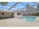 Inviting backyard pool with screened enclosure and ample deck space for entertaining at 9241 Cochise Ln, Port Richey, FL 34668