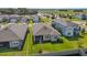Aerial view of a home with a well-manicured lawn and a screened patio area at 9271 Rally Spring Loop, Wesley Chapel, FL 33545