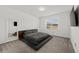 Modern bedroom featuring a platform bed, carpeted floor, and natural light at 9271 Rally Spring Loop, Wesley Chapel, FL 33545