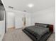Carpeted bedroom with a platform bed, neutral walls, and ensuite bathroom access at 9271 Rally Spring Loop, Wesley Chapel, FL 33545