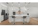 Modern kitchen with a large island, barstool seating, and stainless-steel appliances at 9271 Rally Spring Loop, Wesley Chapel, FL 33545