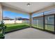 The screened lanai offers a serene view of the meticulously maintained backyard and a lovely garden at 9271 Rally Spring Loop, Wesley Chapel, FL 33545