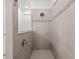 Walk-in shower features updated tile, shower head, and glass partition wall at 9271 Rally Spring Loop, Wesley Chapel, FL 33545
