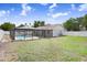 Spacious backyard with a screened-in pool and white fencing, offering privacy and outdoor enjoyment at 1017 Cameo Crest Ln, Valrico, FL 33596