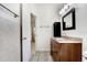 Bathroom with vanity, granite countertop, framed mirror, and tiled floor and walls at 1017 Cameo Crest Ln, Valrico, FL 33596