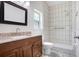 Bathroom with vanity, granite countertop, framed mirror, and a tiled walk-in shower at 1017 Cameo Crest Ln, Valrico, FL 33596