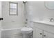 Bright bathroom with a tub and shower, window, and white vanity at 1017 Cameo Crest Ln, Valrico, FL 33596