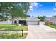 Charming single-story home with a well-manicured lawn and attached two-car garage at 1017 Cameo Crest Ln, Valrico, FL 33596