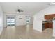 Open-concept living room with hardwood floors and natural light flowing through sliding glass doors at 1017 Cameo Crest Ln, Valrico, FL 33596