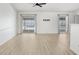 Bright living room featuring new flooring, ceiling fan, and sliding glass doors leading to outdoor pool at 1017 Cameo Crest Ln, Valrico, FL 33596