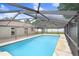 Spacious pool with an in-ground pool, screened enclosure, and a white fence at 1017 Cameo Crest Ln, Valrico, FL 33596