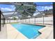 Inviting pool with a screened enclosure, surrounding deck and well-maintained landscaping at 1017 Cameo Crest Ln, Valrico, FL 33596