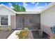 Covered and screened front porch, with brick accents and manicured landscaping at 1017 Cameo Crest Ln, Valrico, FL 33596