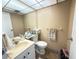 Compact bathroom featuring a vanity, toilet, and ample storage for toiletries at 102 Cambridge Trl # 230, Sun City Center, FL 33573