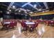 Spacious event hall featuring a stage and tables with seating at 102 Cambridge Trl # 230, Sun City Center, FL 33573
