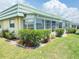 A single-story condo with meticulous landscaping, mulched beds, and thriving greenery at 102 Cambridge Trl # 230, Sun City Center, FL 33573