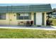 Charming condo with green shutters, front door, and room for seating to enjoy the outdoors at 102 Cambridge Trl # 230, Sun City Center, FL 33573