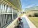 Condo exterior featuring an outdoor seating area and view of adjacent units at 102 Cambridge Trl # 230, Sun City Center, FL 33573
