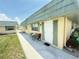 Inviting condo entrance with seating area and well-maintained landscaping at 102 Cambridge Trl # 230, Sun City Center, FL 33573
