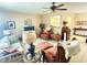Comfortable living room features tile flooring, pass through to kitchen, and bright lighting at 102 Cambridge Trl # 230, Sun City Center, FL 33573