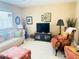 Inviting living room with neutral walls, tile floors, and comfortable seating at 102 Cambridge Trl # 230, Sun City Center, FL 33573