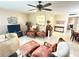 Cozy living room featuring tile flooring, ceiling fan, and comfortable furnishings at 102 Cambridge Trl # 230, Sun City Center, FL 33573
