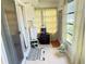 Relaxing sunroom featuring tile flooring, neutral tones, washer/dryer, and natural light at 102 Cambridge Trl # 230, Sun City Center, FL 33573