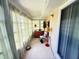Bright sunroom featuring tile flooring, neutral tones, several windows and comfortable seating at 102 Cambridge Trl # 230, Sun City Center, FL 33573