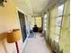 Relaxing sunroom offering natural light, tile flooring, washer/dryer, and views to the backyard at 102 Cambridge Trl # 230, Sun City Center, FL 33573