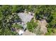 Aerial view of the property showcasing a large roof and surrounding mature trees at 1119 Eau Claire Cir, Tampa, FL 33619