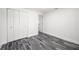 Clean bedroom featuring gray flooring, white walls, and a large closet for storage solutions at 1119 Eau Claire Cir, Tampa, FL 33619