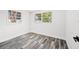 Cozy bedroom with gray floors, white walls, and two windows allowing for plenty of natural light at 1119 Eau Claire Cir, Tampa, FL 33619