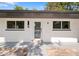 Close-up of the facade featuring a front door and window details at 1119 Eau Claire Cir, Tampa, FL 33619