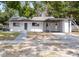 Charming single story home featuring a carport and modern design elements at 1119 Eau Claire Cir, Tampa, FL 33619