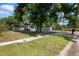 Charming single-story home with a covered carport and a large shade tree at 1119 Eau Claire Cir, Tampa, FL 33619